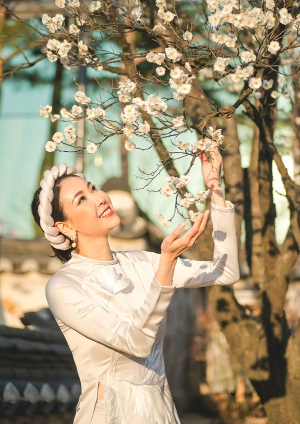 Người đẹp thích thú ngắm hoa anh đào đang nở rộ.    