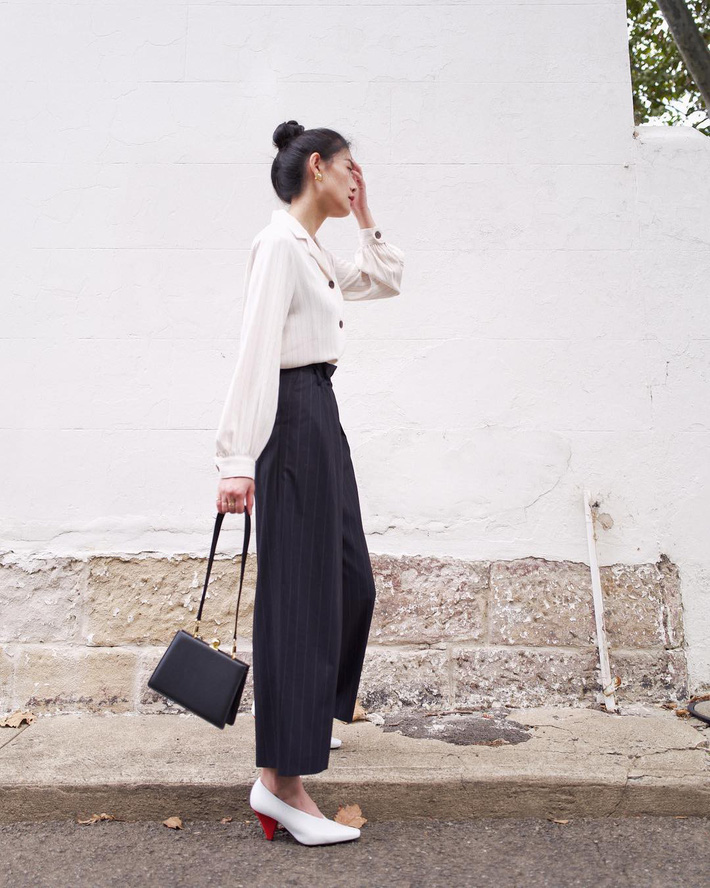 Set đồ đậm chất công sở nhưng nhìn không hề bị nhàm chán, chiếc áo blouse tay bồng được cô nàng kết hợp khá ăn ý cùng quần culottes. Nếu để ý có thể thấy từ áo đến quần đều có họa tiết sọc dọc, chính họa tiết này giúp bạn nhìn gọn gàng hơn. Bên cạnh đó chiếc túi với kiểu dáng vintage cũng là một chi tiết đắt giá giúp nâng tầm cả set đồ.    