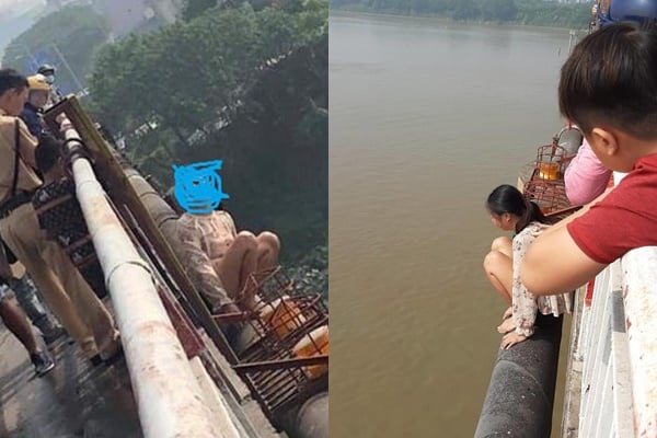 Người phụ nữ trèo qua lan can cầu ngồi khóc lóc.