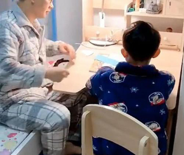 Người đàn ông kèm con học bài.