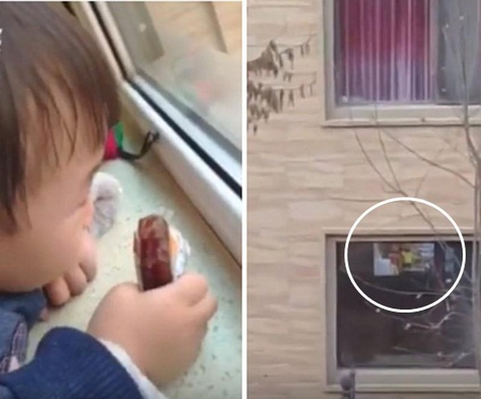 Bé gái ngồi chăm chú xem ké ti vi nhà hàng xóm.