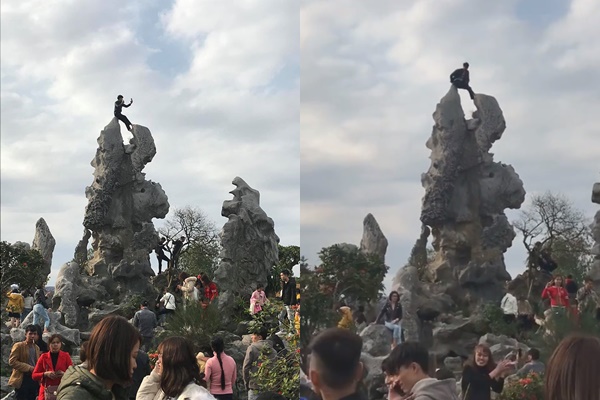 Thanh niên trèo lên tảng đá trong chùa để chụp ảnh.