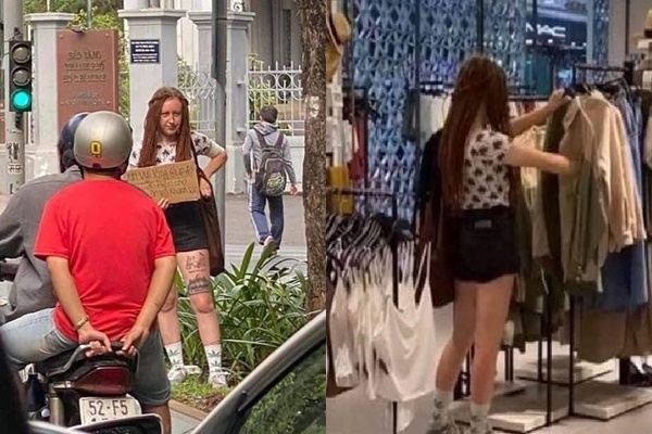 Nữ du khách nước ngoài cầm biển xin tiền trên phố.