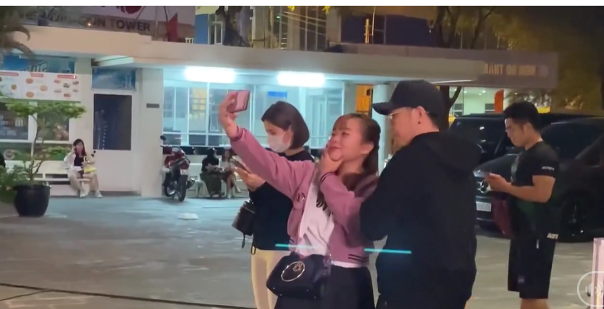 Cô gái mặc áo đen, tóc ngắn đang bấm điện thoại được cho là bạn gái Anh Đức.