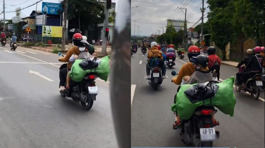 Cậu bé bế em nhỏ về quê cùng mẹ (Ảnh: Chụp màn hình)