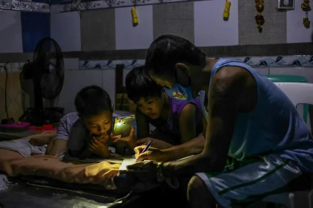 Một ông bố Philippines dạy con học tại nhà.