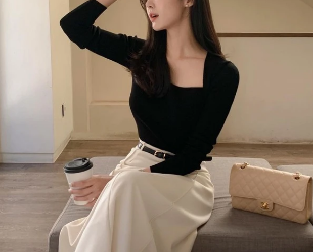 Váy lụa dáng dài phối cùng một chiếc áo thun dài tay ôm sát và giày đế bệt nữ tính. Chi tiết cổ vuông của mẫu áo khéo léo tôn lên thềm ngực hờ hững, đồng thời thao tác sơ vin và việc cố định bằng chiếc thắt lưng da mặt khóa kim loại để khoe vòng eo.    