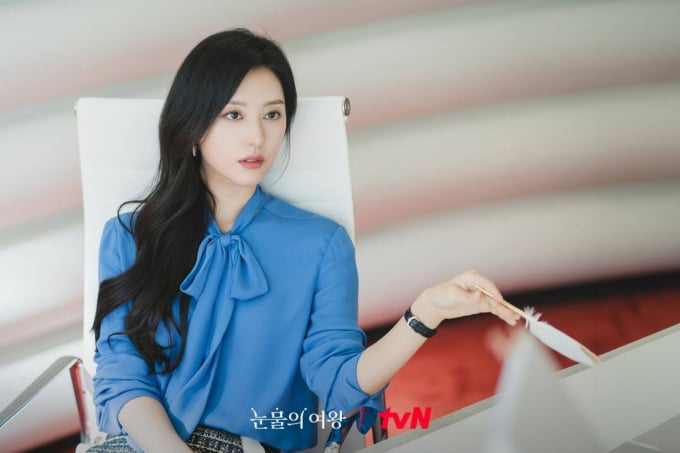 Mẫu áo blouse cổ nơ buộc vốn đã nổi bật, Kim Ji Won còn tăng thêm độ bắt mắt cho outfit bằng cách kết hợp với chân váy vải tweed.     