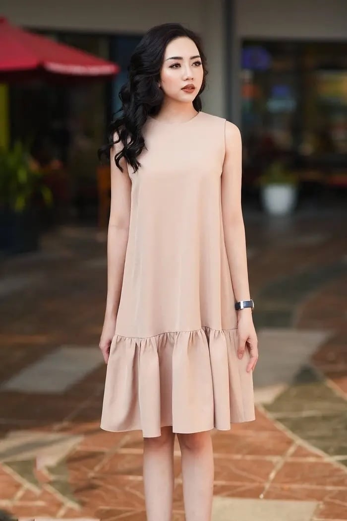 Chiếc đầm suông với phần đáy được cắt may giống hình đuôi cá mang lại dáng vẻ thanh thoát và duyên dáng cho người mặc