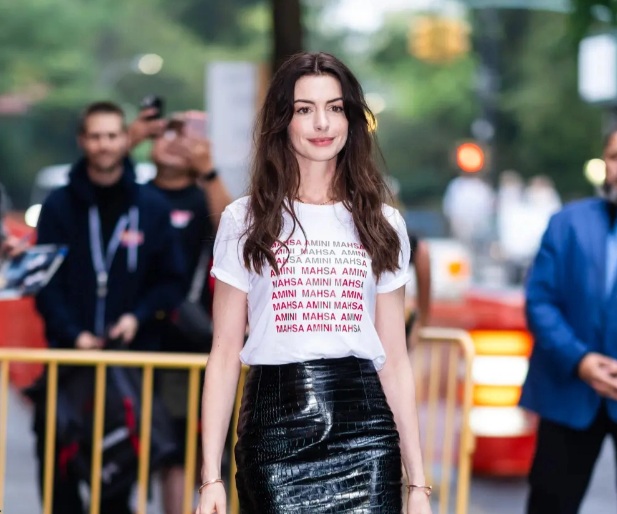 Anne Hathaway diện áo thun trắng với chân váy da, giày mũi nhọn thêm Link Vào SHBET88 Mới Nhất lý tưởng để áp dụng khi diện áo thun, đó là tóc xõa uốn sóng nữ tính, yêu kiều.    