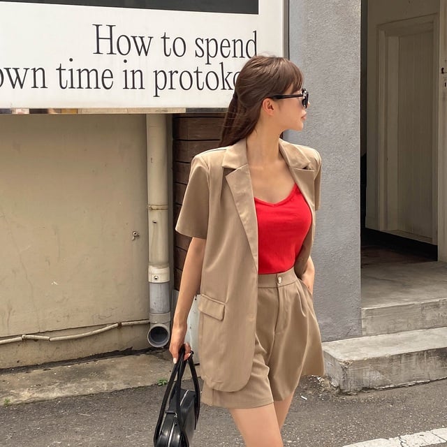 Bộ suit màu be và mix cùng một chiếc áo mang tông màu đỏ. 