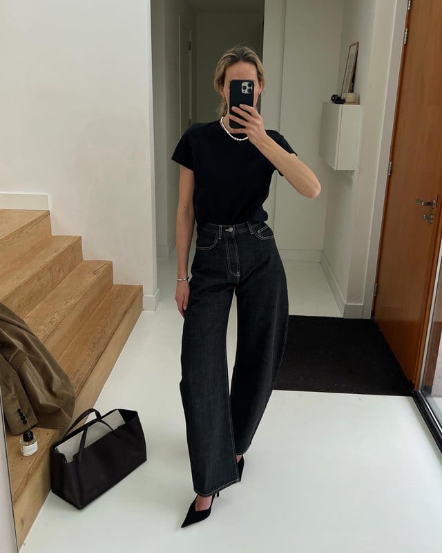 Set đồ gồm áo thun và quần denim đen ghi điểm ở sự trẻ trung và long lanh hơn khi tô điểm vòng cổ ngọc trai.