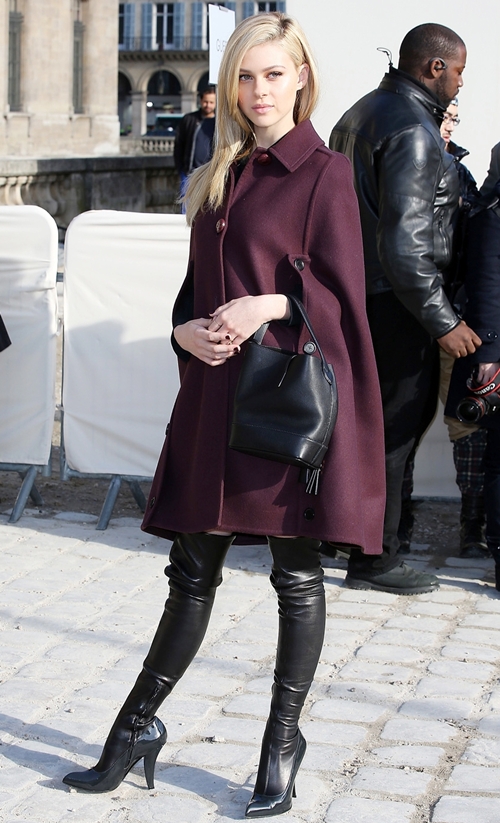 Mỹ nhân Transformer 4 Nicola Peltz mặc áo cape gam bordeaux và đồ da sang trọng đi xem show thời trang ở Pháp.