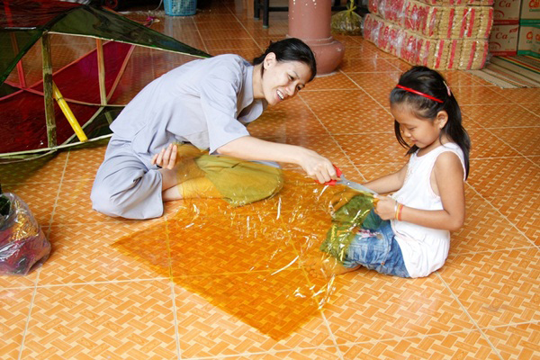 Trang Trần tươi vui chơi đùa với em nhỏ.