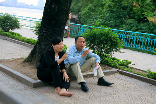 Người dân ngồi vỉa hè, ăn kem giải nhiệt.