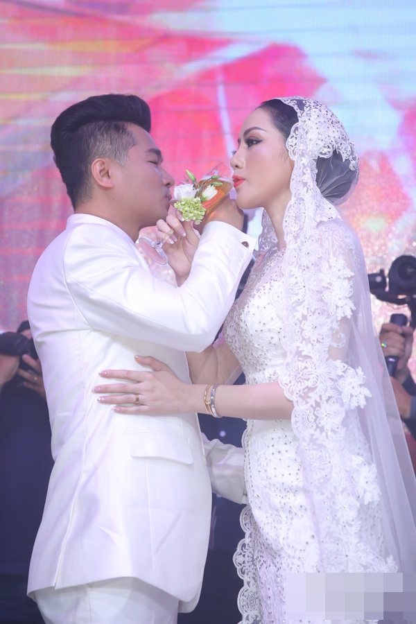 Nam ca sĩ hát tặng cô dâu ca khúc 'Em là vâng trăng của anh' tại tiệc cưới. Cả hai cùng uống rượu giao bôi.