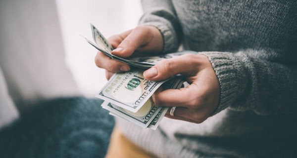 woman-holding-cash-514781336-1491709482554-crop-1491709488214