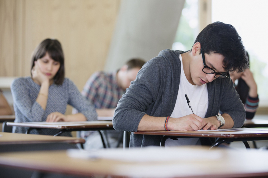 focused-male-college-student-taking-test-at-desk-in-classroom-683735379-5871d20f5f9b584db3aa3f60-15207206476711621820919
