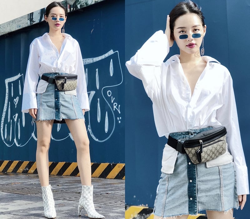 Không thua kém đàn chị, Khánh Linh khẳng định gu thẩm mỹ sành điệu với sơ mi trắng tay loe, bắt cặp cùng chân váy denim. Điểm làm nên sự phá cách cho bộ cánh của cô nàng chính là túi belt của Gucci ở ngang hông và đôi boots ton-sur-ton “đắt giá”.    