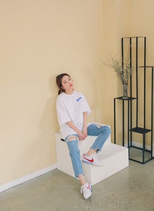 Quần jeans rách tả tơi cũng là một điểm nhấn cho set đồ đơn giản với áo thun và giày thể thao    