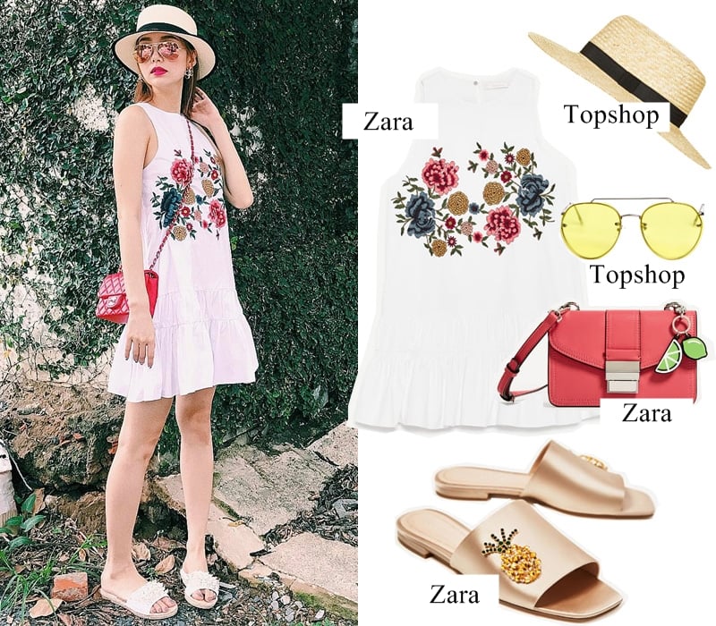 Minh Hằng nổi bật trong mẫu đầm trắng thêu hoa tuyệt đẹp của Zara, phối cùng dép quai ngang năng động. Ngoài chiếc túi đỏ xinh xắn, cặp phụ kiện mũ cói vành tròn và kính mắt tráng gương càng giúp bộ cánh của người đẹp thêm thời thượng. (Váy trắng: 999.000VND – Mũ vành tròn: 920.000VND – Kính mắt: 530.000VND – Túi: 649.000VND – Sandals: 1.499.000VND)    