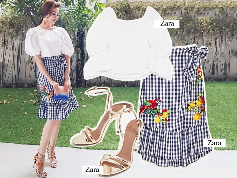 Thanh Hằng bắt nhịp trào lưu họa tiết kẻ gingham với thiết kế chân váy thêu, phối cùng áo blouse trắng tay phồng, khoe vẻ bay bổng, nữ tính. (Áo: 899.000VND – Chân váy: 1.499.000VND – Sandals ánh kim: 999.000VND)    