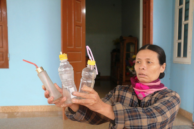 Bà Phạm Thị Nghĩa (vợ ông Năm) đưa ra nhiều chai lọ có cắm ống hút và cho rằng đây là dụng cụ 